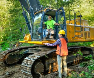 MFWWC Project Manager Audrey Squires discusses the plan with a Haley Construction equipment operator.